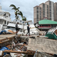Residents inspect damage to a marina as boats are partially submerged in the aftermath of Hurricane Ian in Fort Myers, Florida, on September 29, 2022.